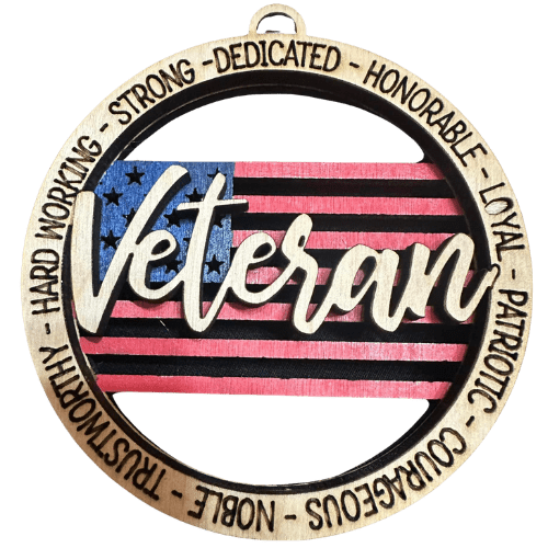 Veteran laser engraved over an American flag with the words dedicated honorable loyal patriotic courageous noble trustworthy hard working strong in a circle along the outside.